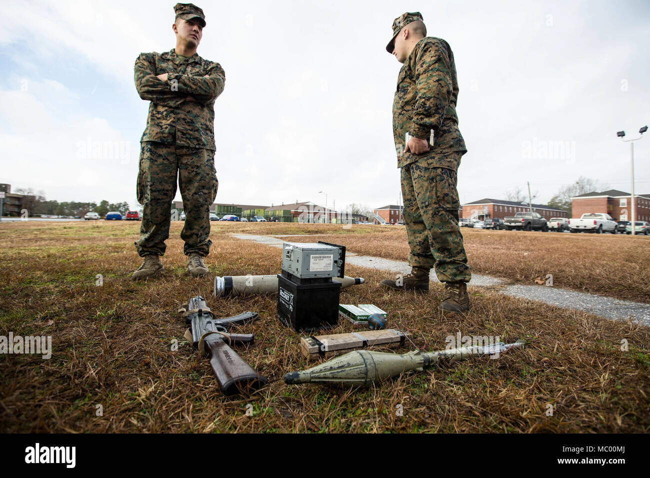 U.S. Marines with Battalion Landing Team, 2nd Battalion, 6th Marine Regiment, 26th Marine Expeditionary Unit (MEU), discuss their course of action during vehicle-borne improvised explosive device (VBIED) training on Camp Lejeune, N.C., Jan. 11, 2018. The two-day course was held to educate Marines on the proper procedures of inspecting vehicles and civilians for potential threats while also giving them the opportunity to practice techniques in preparation for the upcoming deployment. (U.S. Marine Corps photo by Lance Cpl. Tojyea G. Matally) Stock Photo