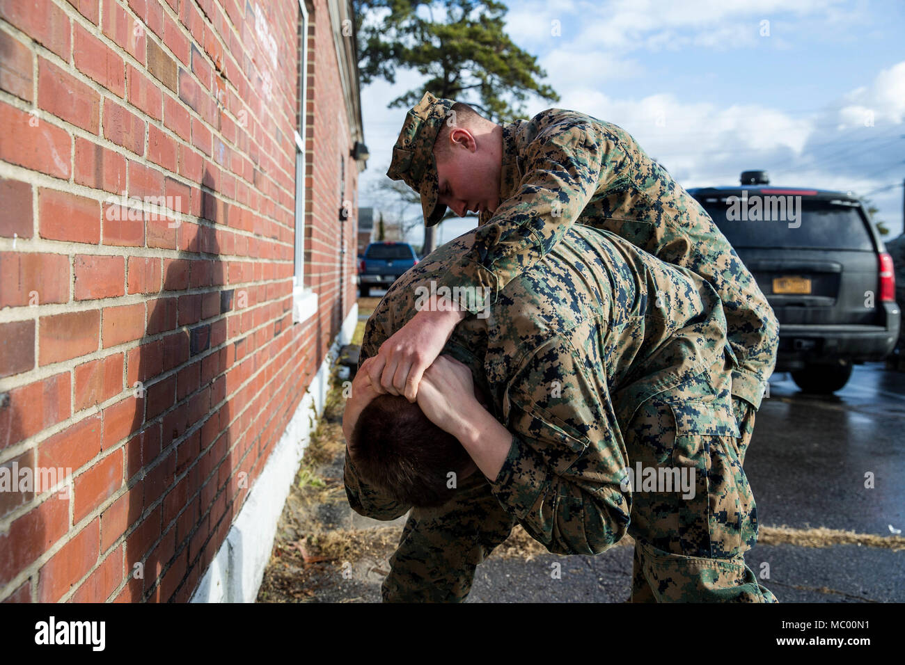 U.S. Marine Lance Cpl. Conor D. Scovill, right, a rifleman with Battalion Landing Team, 2nd Battalion, 6th Marine Regiment, 26th Marine Expeditionary Unit (MEU), physically searches a simulated suspect during vehicle-borne improvised explosive device (VBIED) training on Camp Lejeune, N.C., Jan. 11, 2018. The course was held to educate Marines on the proper procedures of physically inspecting vehicles and civilians for potential threats while also giving them the opportunity to practice techniques in preparation for the upcoming deployment. (U.S. Marine Corps photo by Lance Cpl. Tojyea G. Matal Stock Photo