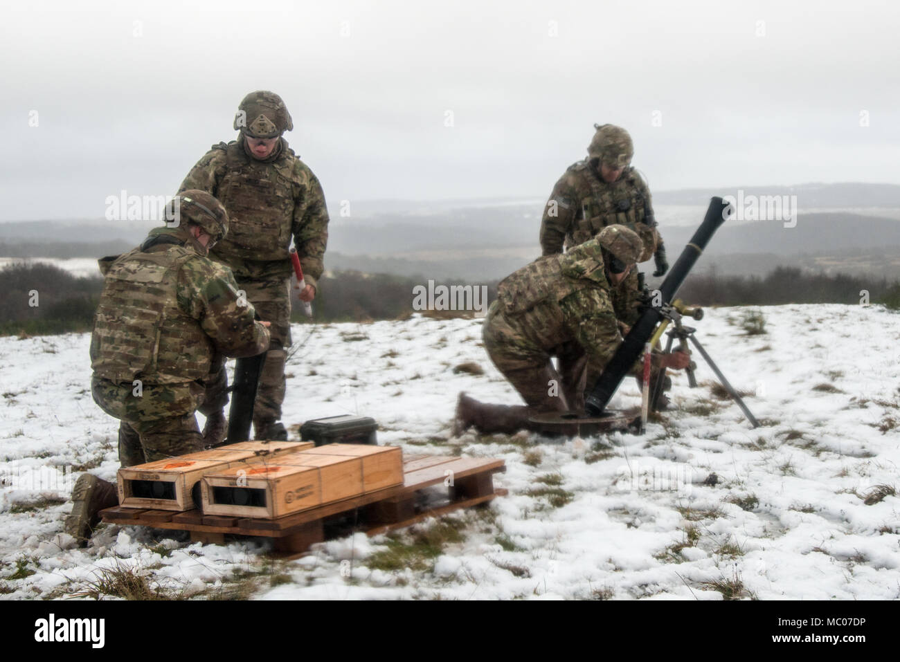 U.S. Soldiers assigned to Headquarters and Headquarters Company, 1st Battalion, 503rd Infantry Regiment, 173rd Infantry Brigade Combat Team (Airborne), fire the M252A1 81mm Mortar System at Mortar Firing Point 1 in the Baumholder Military Training Area, Germany, Jan. 18, 2018. The training provided the Mortarmen the opportunity to increase their proficiency and familiarization with the weapon system. The 173rd Airborne Brigade is the U.S. Army’s Contingency Response Force in Europe, providing rapidly deploying forces to the U.S. Army Europe, Africa and Central Command Areas' of Responsibility  Stock Photo