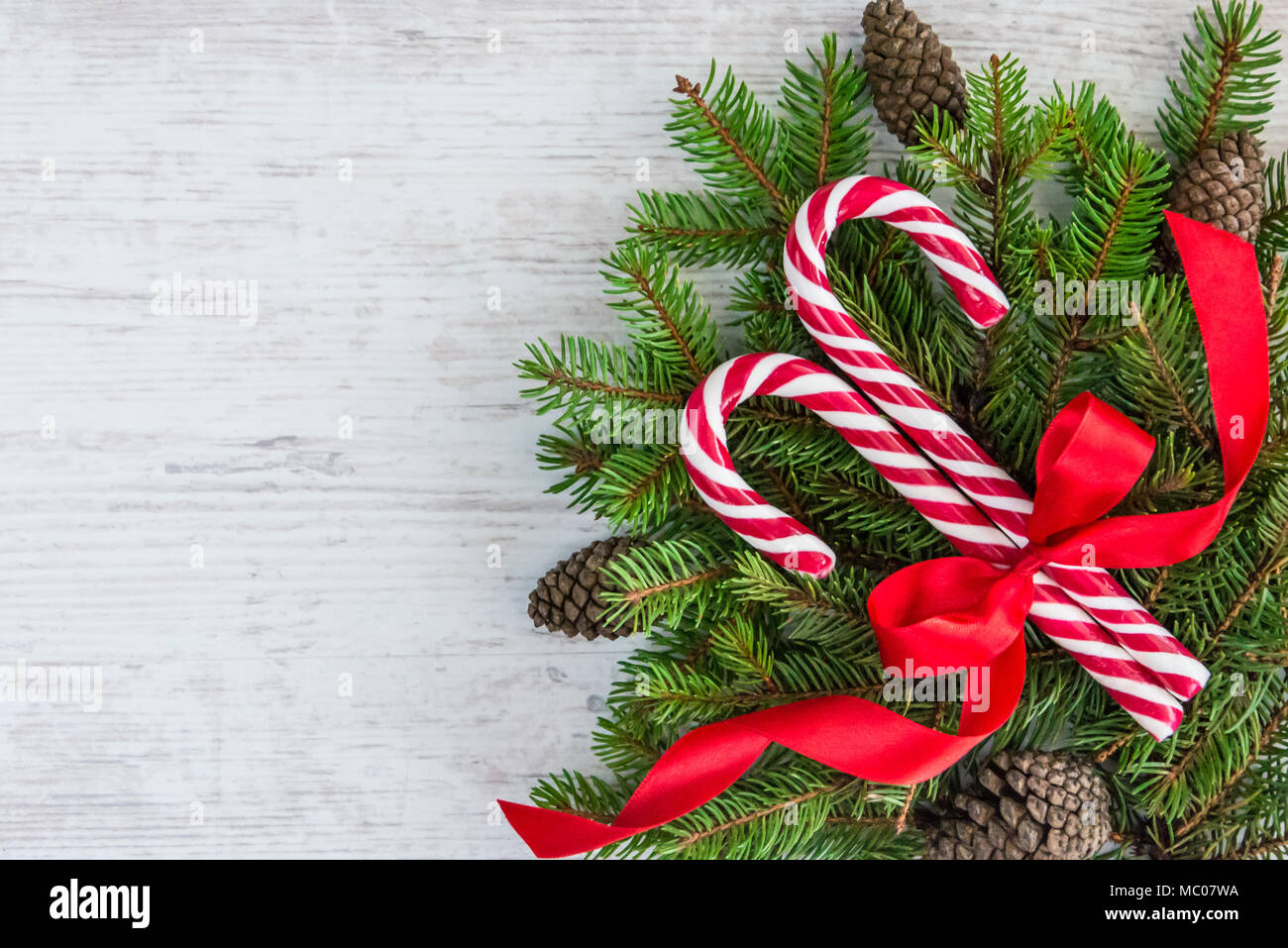 Top view of a fir tree and candy cones tied with a red bow over an old ...