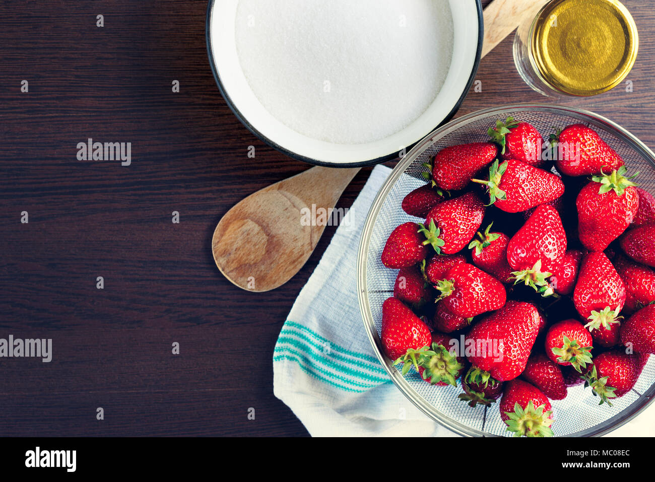 Top view of fresh strawberries and sugar. Strawberry jam ingredients prepared to be cooked. Stock Photo