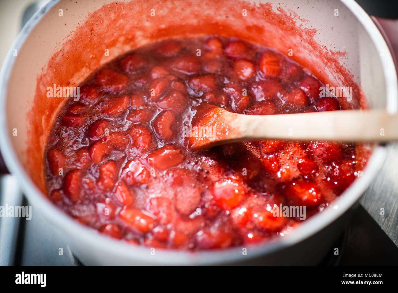 Close up of a simmering homemade strawberry jam. Stock Photo