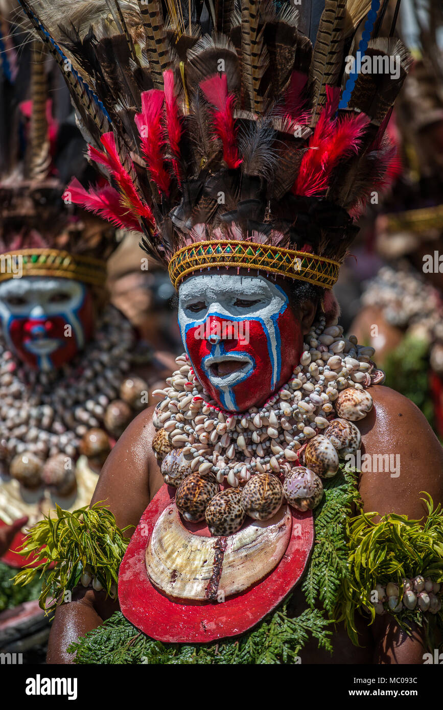 a Western Highlands women with face painting, feathers headdress and ...
