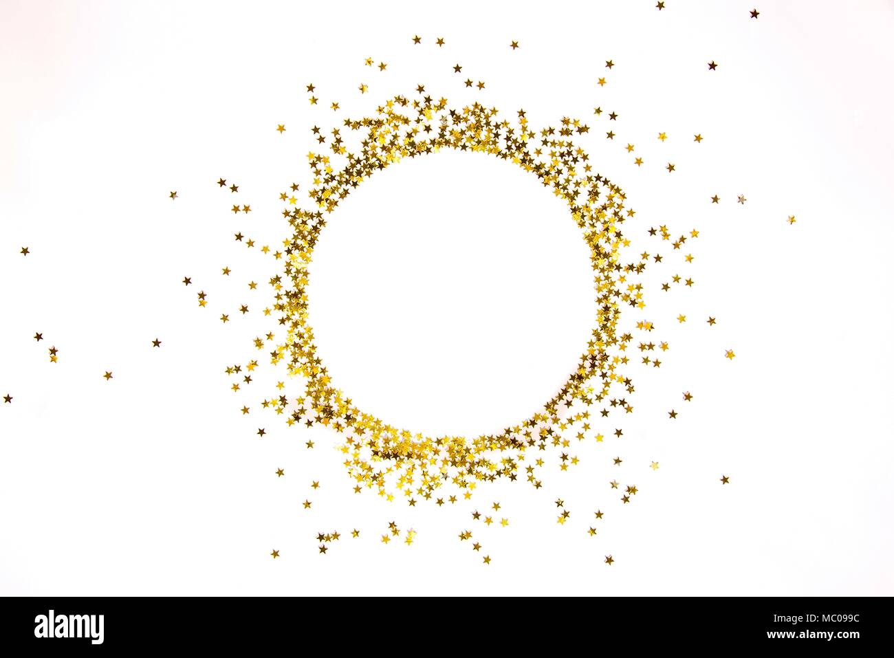 Star shaped golden sequins frame arranged in circle. Stock Photo