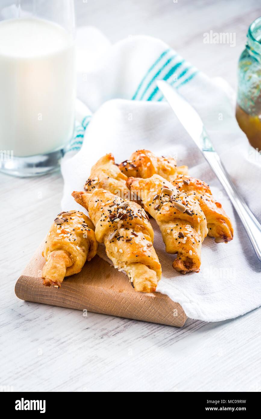 Close up of home baked mini croissants covered with seeds mix. Morning breakfast. Stock Photo