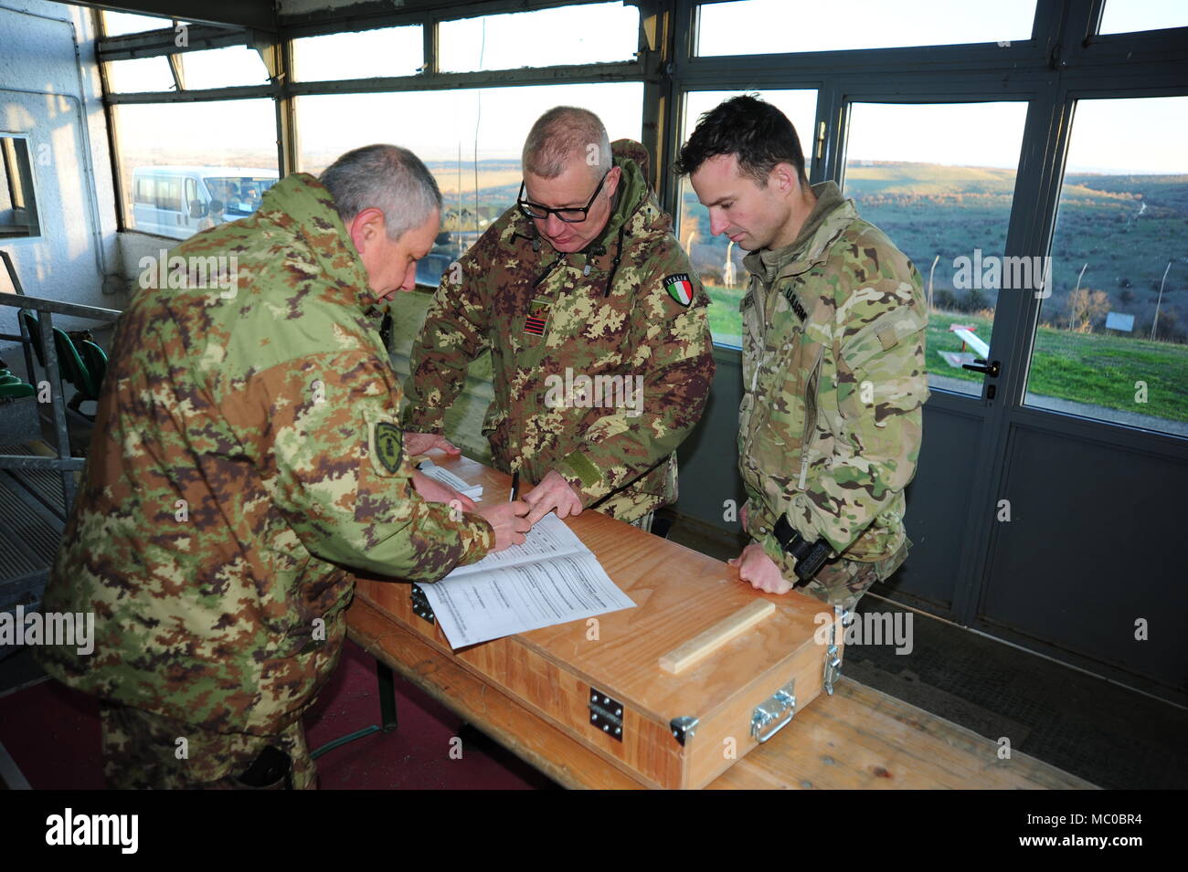 From left, Italian Army 1st Lgt. Giulio Fabbri, Director of Monte Romano Training Area, Italian Army Sgm. Massimo Giordano, liaison officer USA SETAF G3 Vicenza and 1st Lt. Jonathan P. MesserJan, plan the activity during the Exercise Baree  Jan. 18, 2018, Monte Romano training area, Italy. (photo by Elena Baladellireleased). Stock Photo
