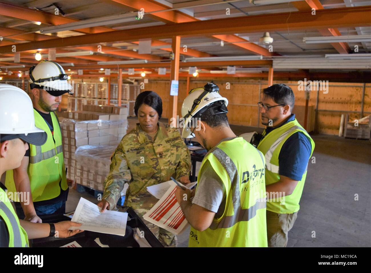 PONCE, Puerto Rico – Master Sgt. Tatshee L. Simmons, Illinois Army National  Guard, goes over the day's inbound materials schedule with members of her  team Jan. 16, at the Port of Ponce