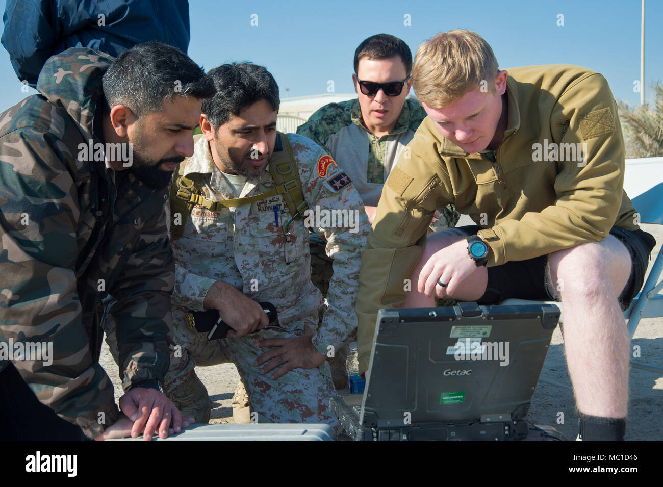180109-N-XE158-0008 Mohammed Al-Ahmad Naval Base, KUWAIT (Jan. 9, 2018) Mineman 2nd Class Dylan Duncan, assigned to Commander, Task Group 56.1, demonstrates pre-mission checks on an unmanned underwater vehicle to Kuwait Naval Force explosive ordnance disposal technicians during a training evolution as part of exercise Eager Response 18. Eager Response 18 is a bilateral explosive ordnance disposal military exercise between the State of Kuwait and the United States. The exercise fortifies military-to-military relationships between the Kuwait Naval Force and U.S. Navy, advances the operational ca Stock Photo