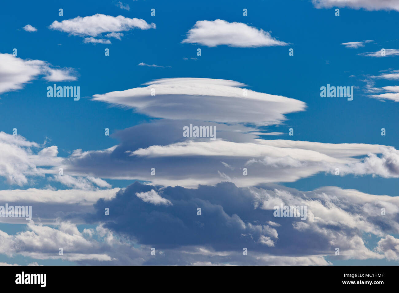 Lenticular clouds (Altocumulus lenticularis) resembling a UFO, in the sky above Kanab, Utah Stock Photo