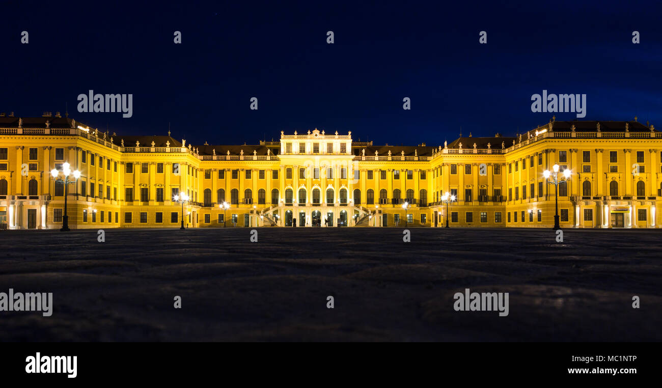 Schönbrunn Palace at night in gold light illumination. Low, wide angle perspective. Vienna, Austria, 25 March 2017 Stock Photo