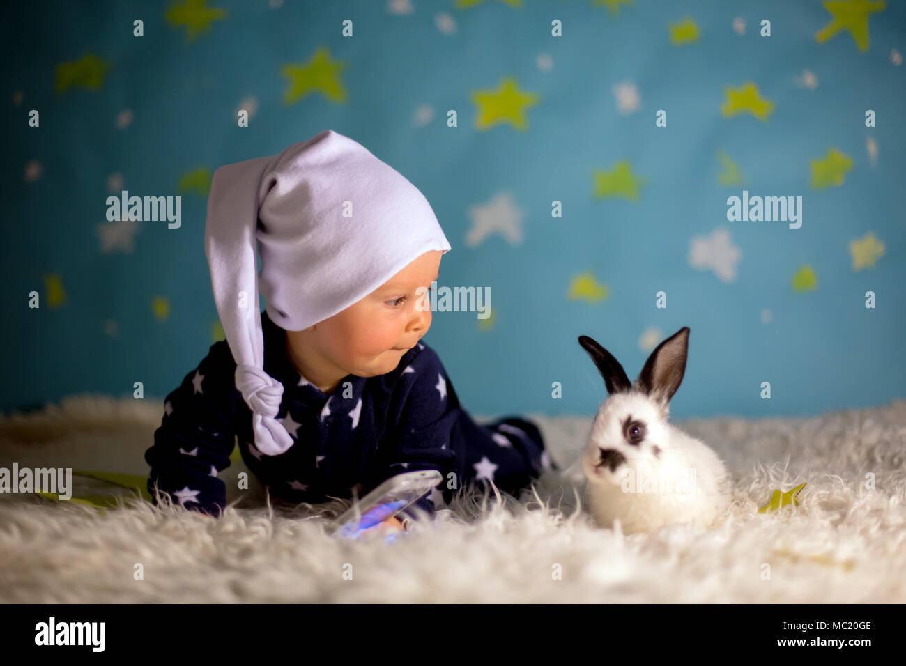 Little Child Baby Boy With Cute White Bunny And Moon On A Blue