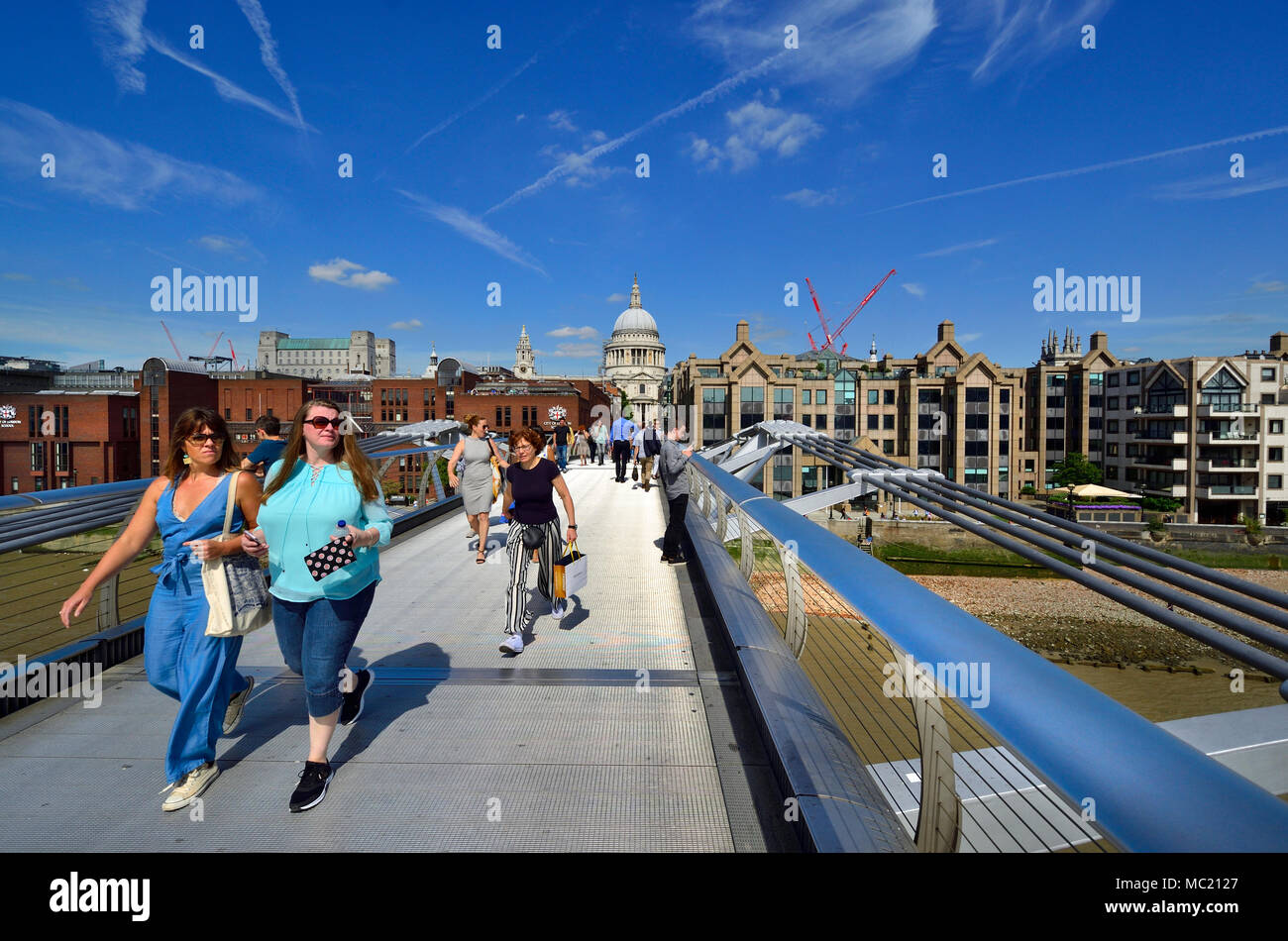 London, England, UK. People crossing the Millennium Bridge, towards St Paul's Cathedral Stock Photo