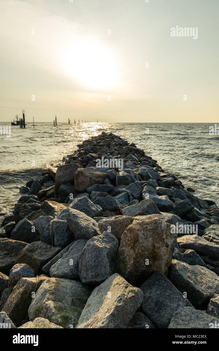 Inspirational landscape scenery of sunset at Redang Beach with rocks and ocean as composition in Sekinchan, Selangor, Malaysia during evening. Stock Photo