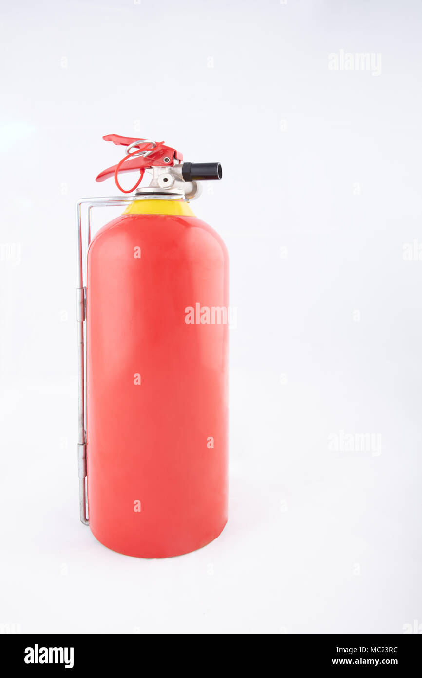 Side view of a portable red fire extinguisher on a white surface with copy space, High