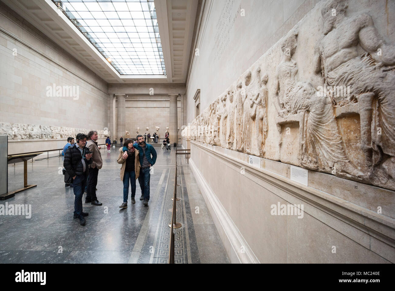 London. England. Visitors to the British Museum looking at the ancient Parthenon Frieze (Elgin Marbles), in the Duveen Gallery, from the Parthenon on  Stock Photo
