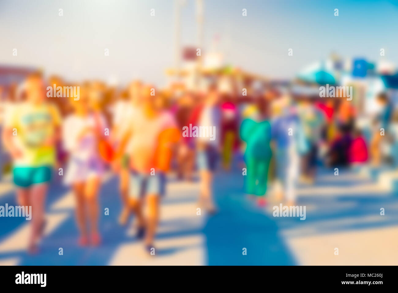 Blur Tourist walking in vivid colorful sunny day on the beach side Stock Photo