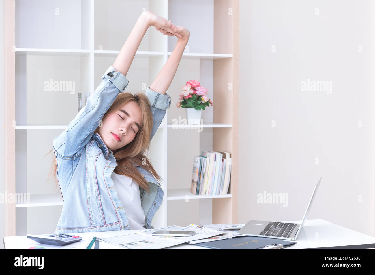 Asian young business women stretching hands in office after finish her work Stock Photo