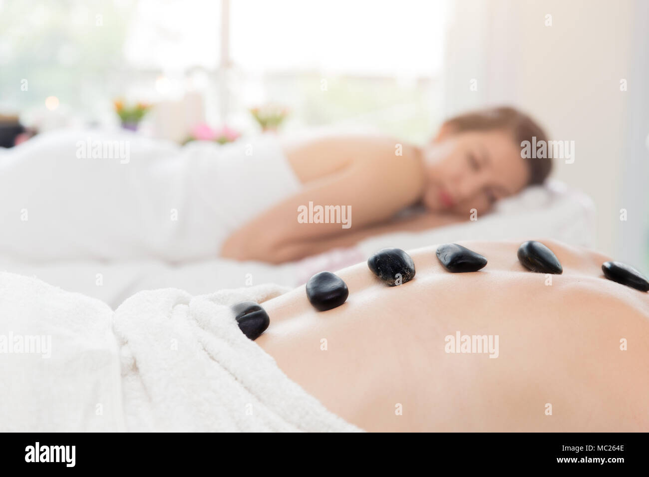 Hot and Cold Stones Massage in Spa for Back Pain Relief and Relaxation Stock Photo