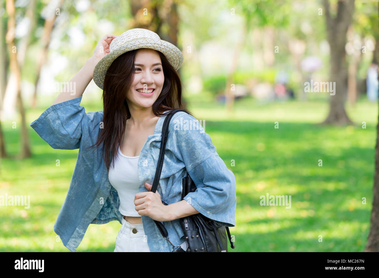 Freedom and Finding Concept: Casual cute smart Asian women walking in the park in summer for holiday relax Stock Photo