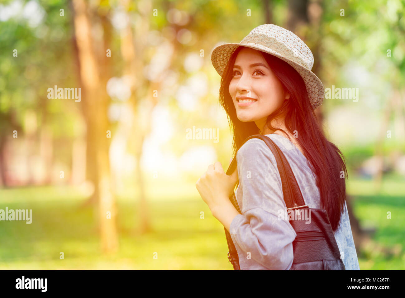 Freedom and Finding Concept: Casual cute smart Asian women walking in the park in summer for holiday relax Stock Photo