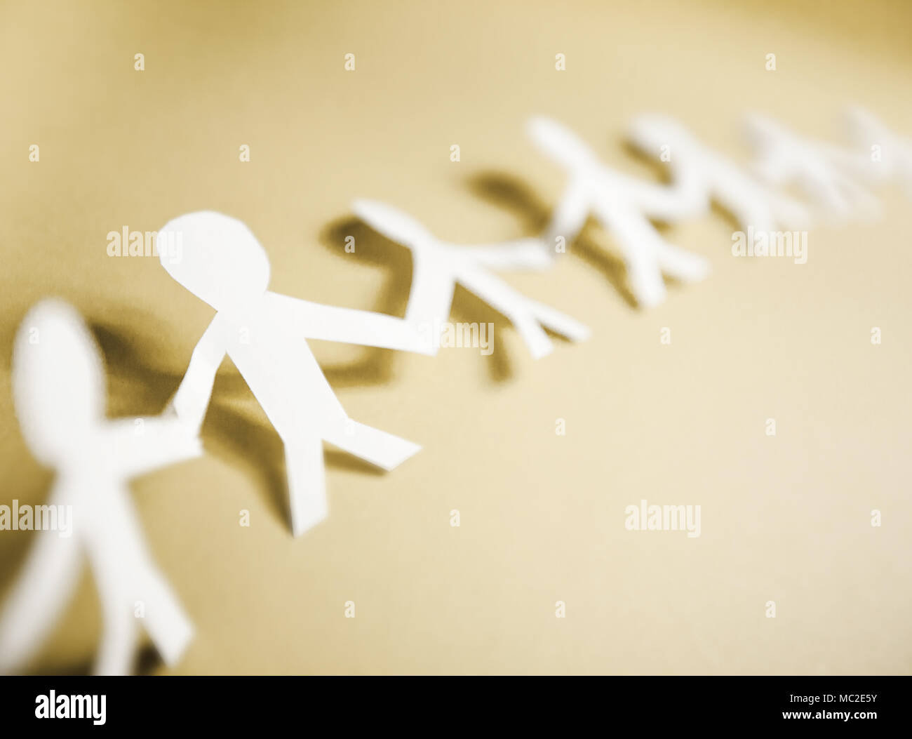 Connected support together, team paper doll people chain Stock Photo