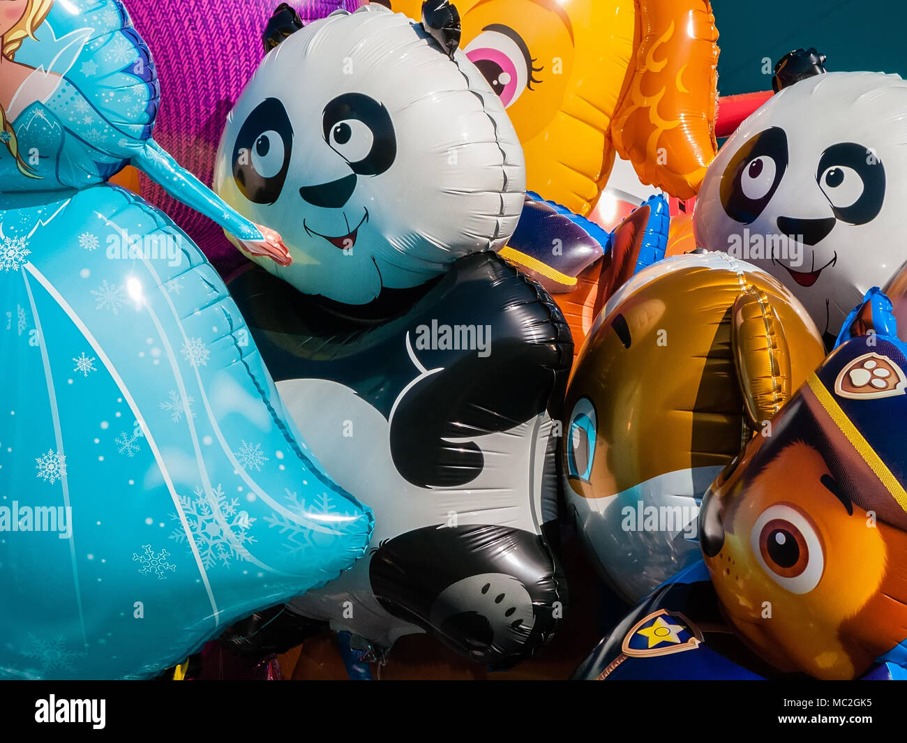 Guimaraes, Portugal. Balloons with the shape of cartoon characters on sale at concert of band for children Stock Photo