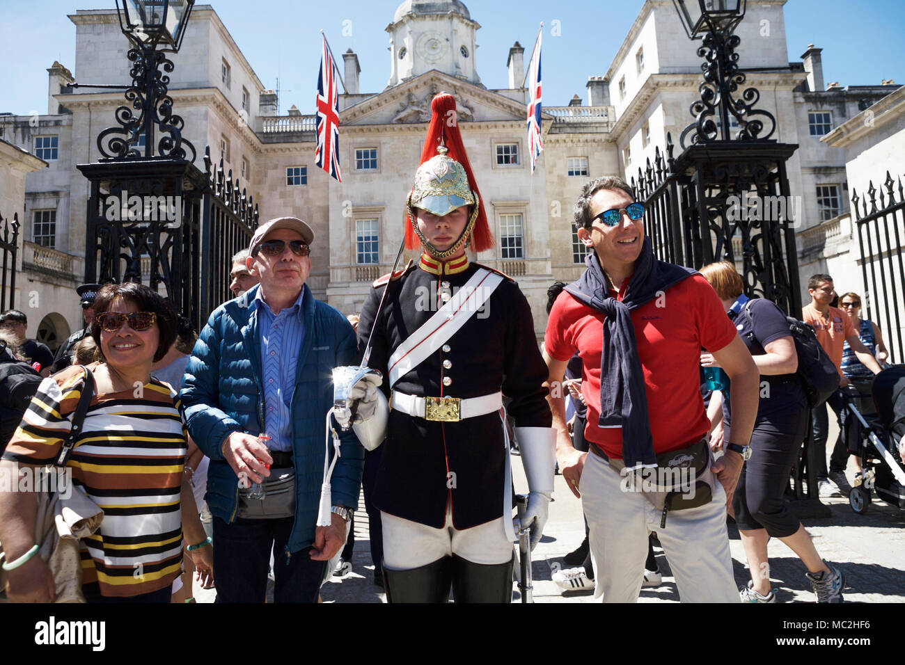 London tourism. London tourists pose with Trooper, Horseguards Parade, Whitehall, London, UK. Tourism London. Stock Photo