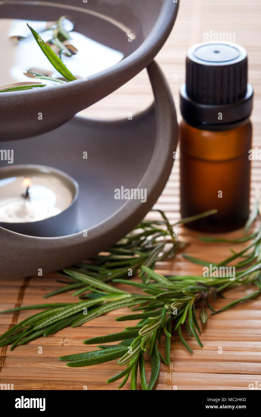 Essential oil with rosemary and oil burner Stock Photo