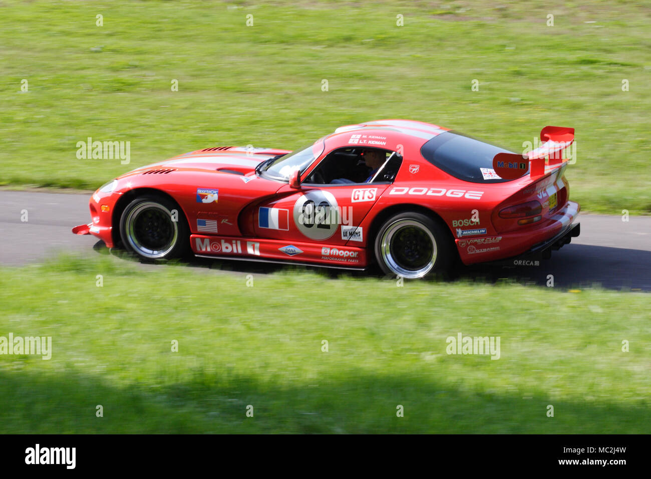 Red Dodge Viper racing car driving fast on a country road. Stock Photo
