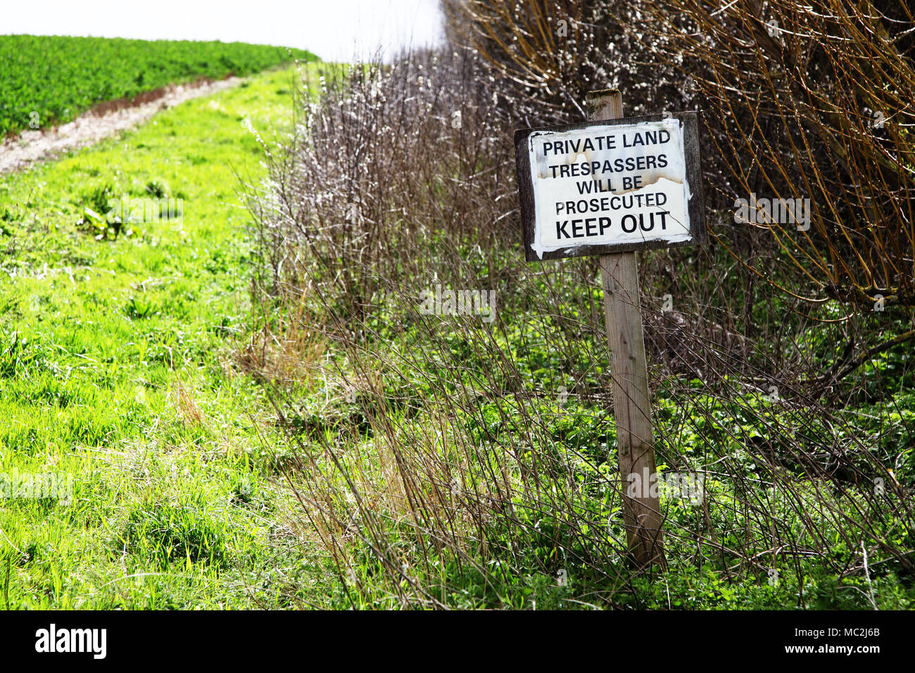 Private land trespassers will be prosecuted keep out sign signage signpost. Stock Photo