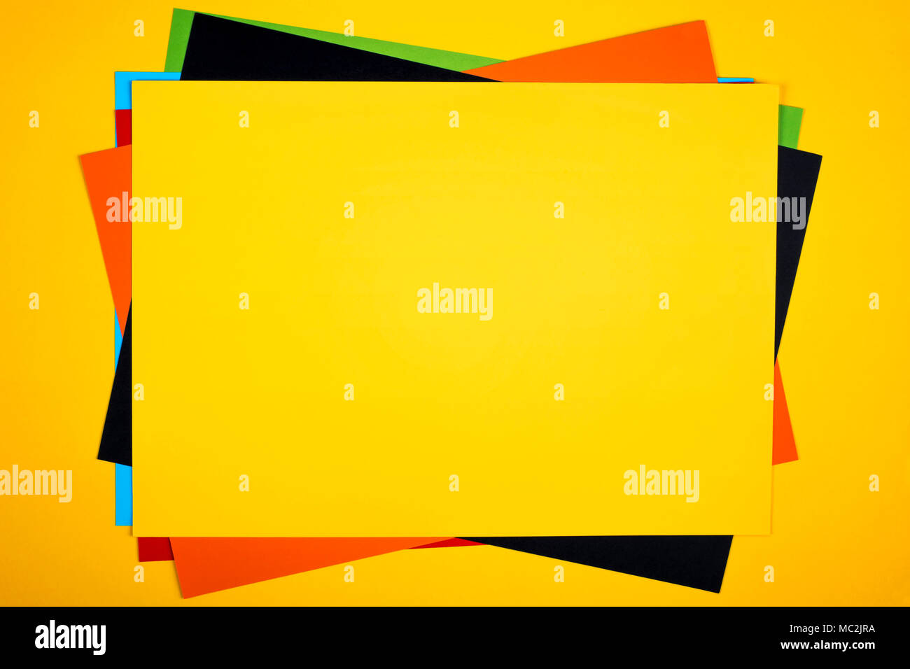 Colorful paper sheets stack on yellow background Stock Photo - Alamy