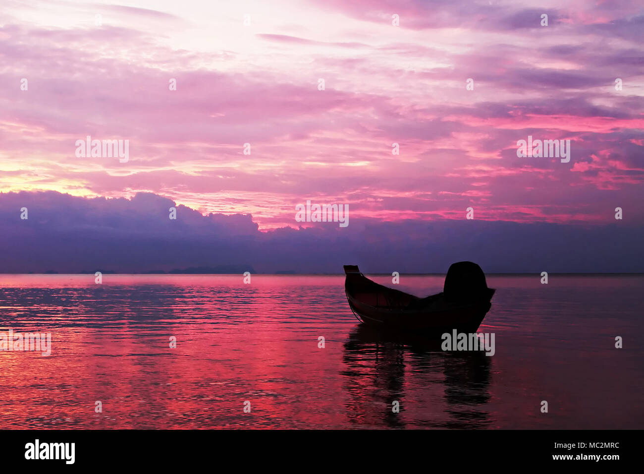 Boat in the sea silhouette on the sunset Stock Photo - Alamy