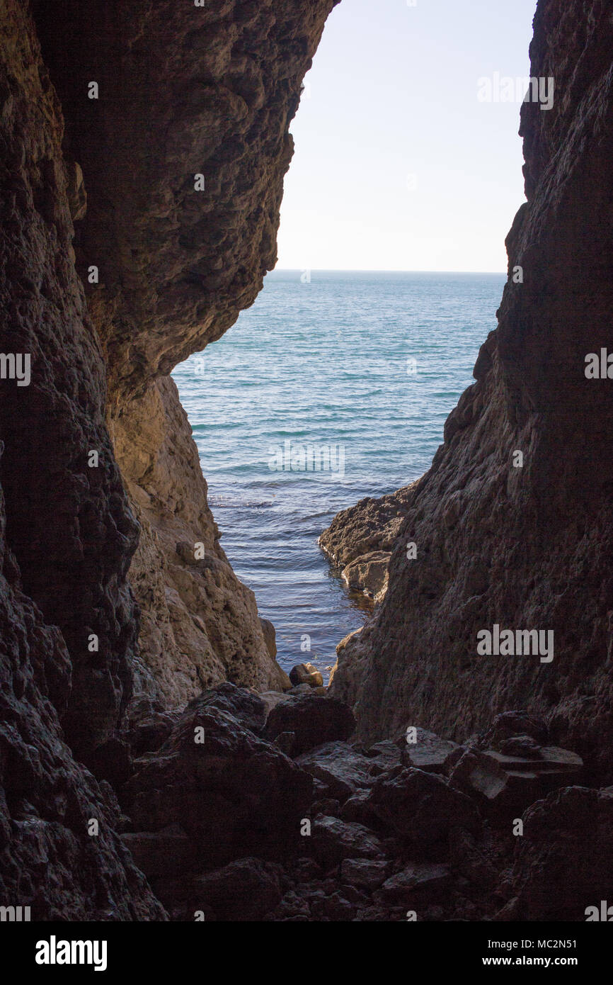 Stunning views of the sea from the natural cave. Inside view. Stock Photo