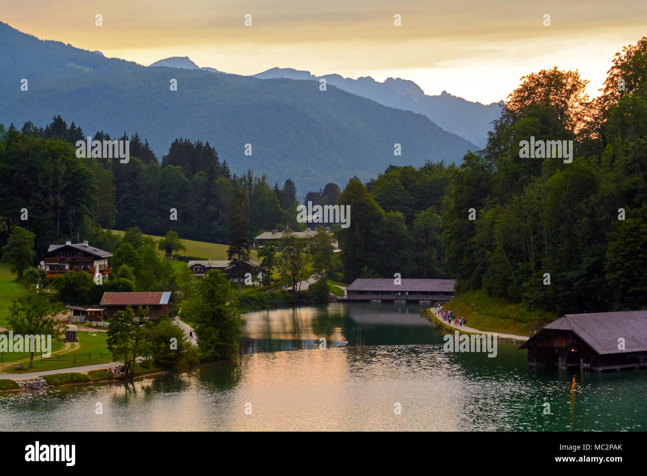 Mountain lake shore and country houses at dusk Stock Photo