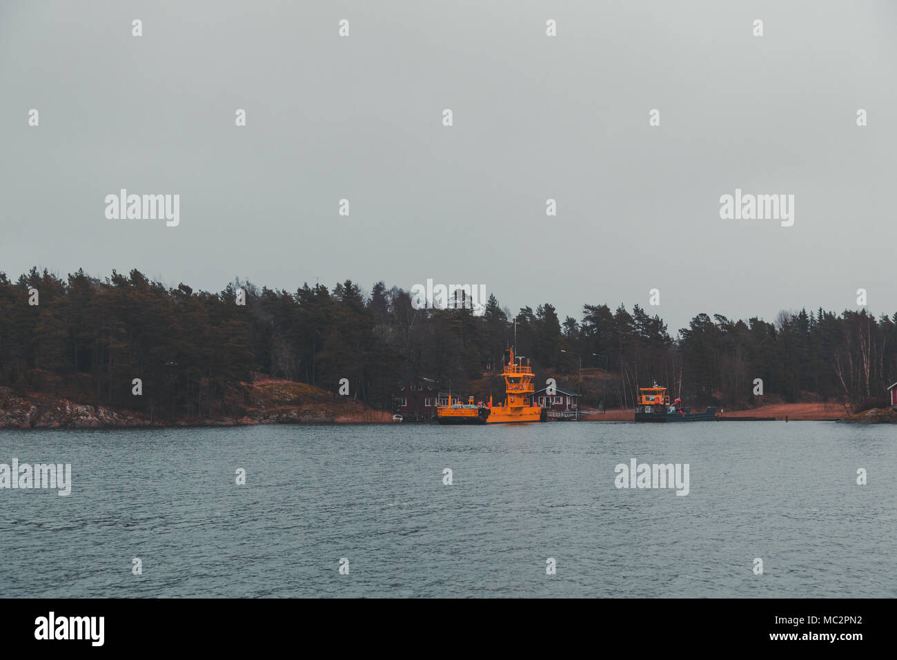 Cable ferry transporting cars over Barosund on an autumn day Stock Photo