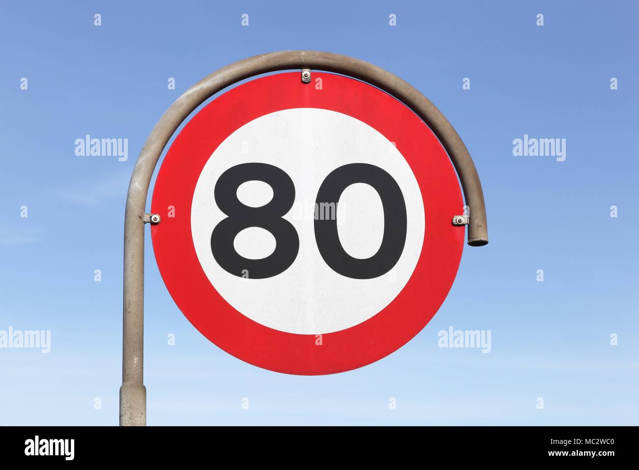 Speed limit traffic sign 80 on the road Stock Photo