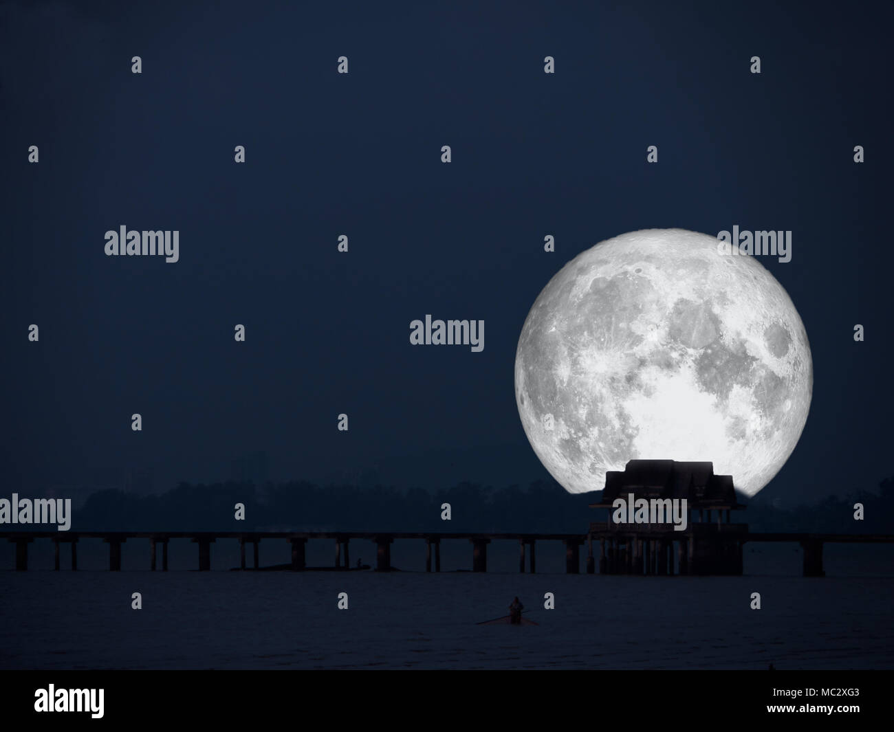 super full moon back of abandon pavillion in night sea, Elements of this image furnished by NASA Stock Photo