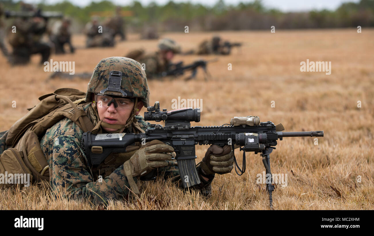 A Marine with 1st Battalion, 2nd Marine Regiment, 2nd Marine Division, listens for instruction at a platoon live-fire range during a training exercise at Camp Lejeune, N.C., Jan. 23, 2018. The training is meant to maintain proficiency at the squad and platoon-level of warfighting by patrolling, breaching obstacles, and conducting live-fire movements to take an objective. (U.S. Marine Corps photo by Lance Cpl. Ashley McLaughlin) Stock Photo
