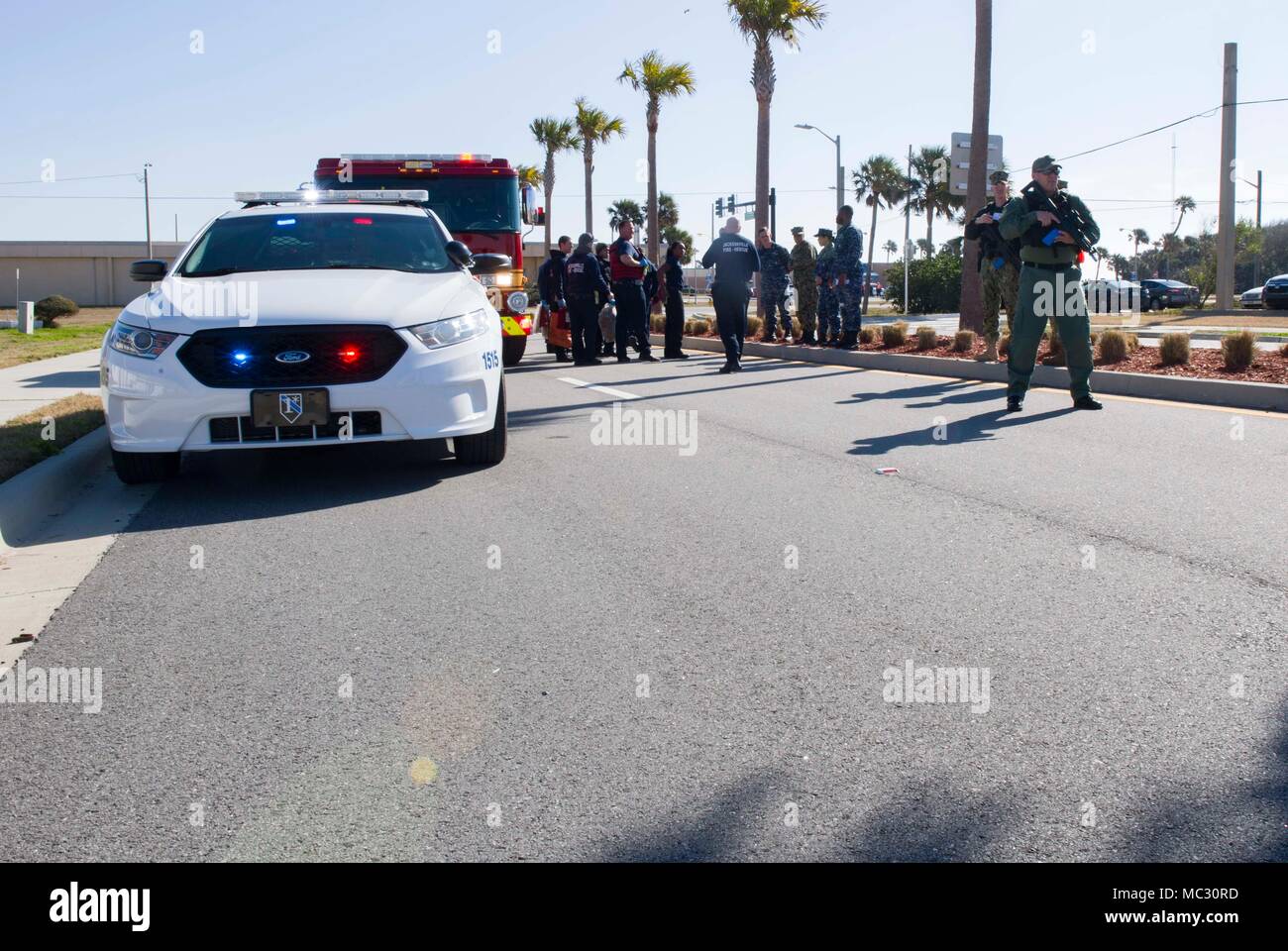 180130-N-TP832-099 JACKSONVILLE, Fla. (Jan. 30, 2018) Sailors and Firemen  assigned to Jacksonville Fire and Rescue, and police officers assigned to  Jacksonville Beach Police Department respond to an active shooter drill at  Naval