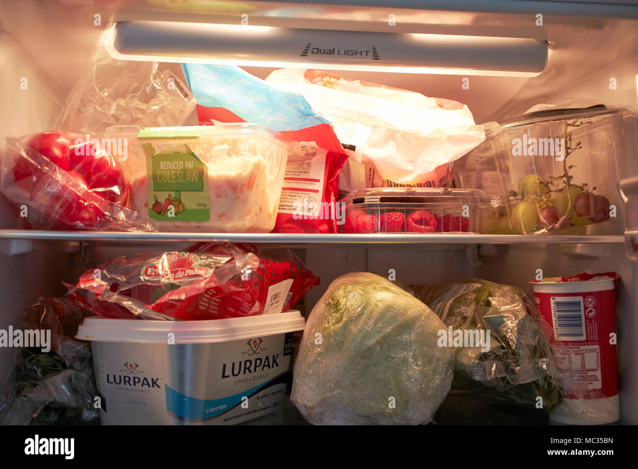 Refrigerator filled vegetables in plastic hires stock photography and