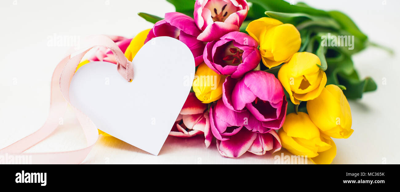 Greeting card - Pink and yellow tulips on a white background Stock ...