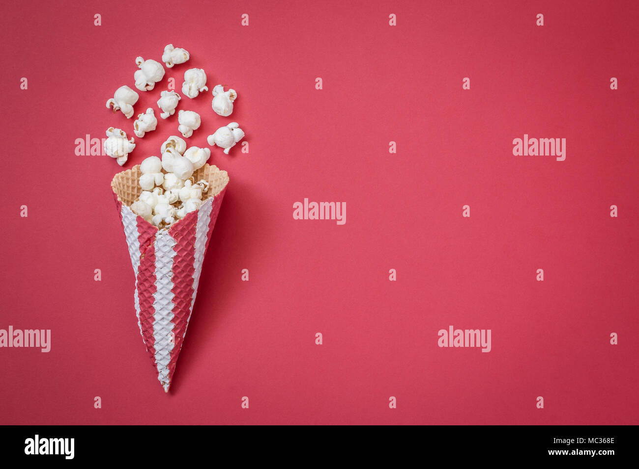 Flat lay of ice cream cone with popcorn isolated on red background minimal  creative concept Stock Photo - Alamy