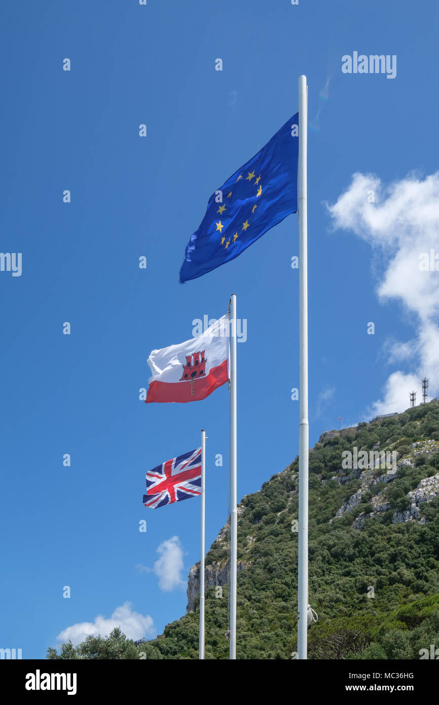 GIBRALTAR, SPAIN: 12-MAY 2017: The EU flag, The Flag of Gibraltar and the Union Jack flag on the Rock of Gibraltar in May 2017. Stock Photo