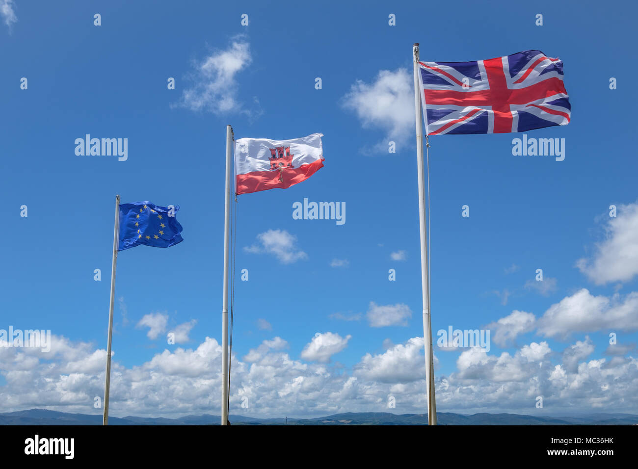 GIBRALTAR, SPAIN: 12-MAY 2017: The EU flag, The Flag of Gibralta and the Union Jack flag on the Rock of Gibraltar in May 2017. Stock Photo