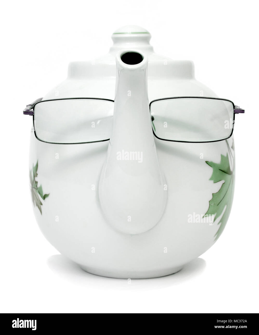 Porcelain teapot with glasses on a nose Stock Photo Alamy