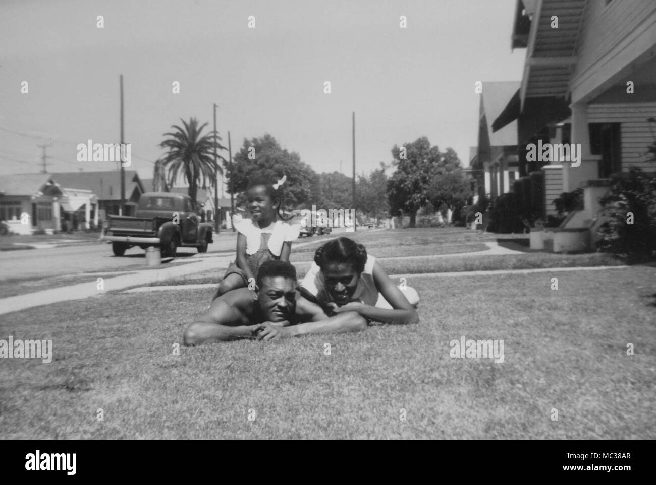 A young African-American family poses on the front lawn of the Los Angeles, California home, ca. 1947. Stock Photo