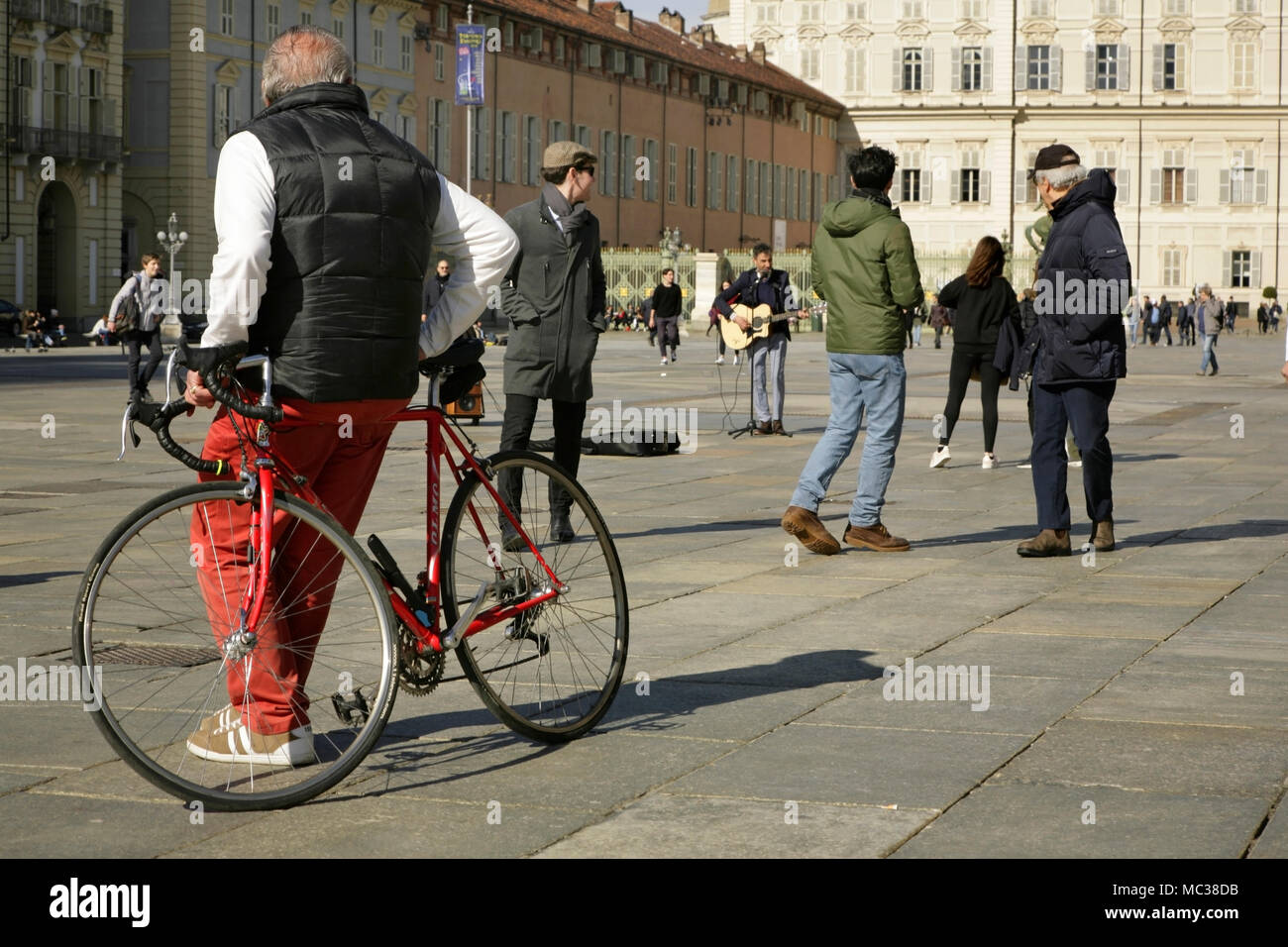 People watching street entertainer singing, Piazza Castello, Turin, Italy. Stock Photo