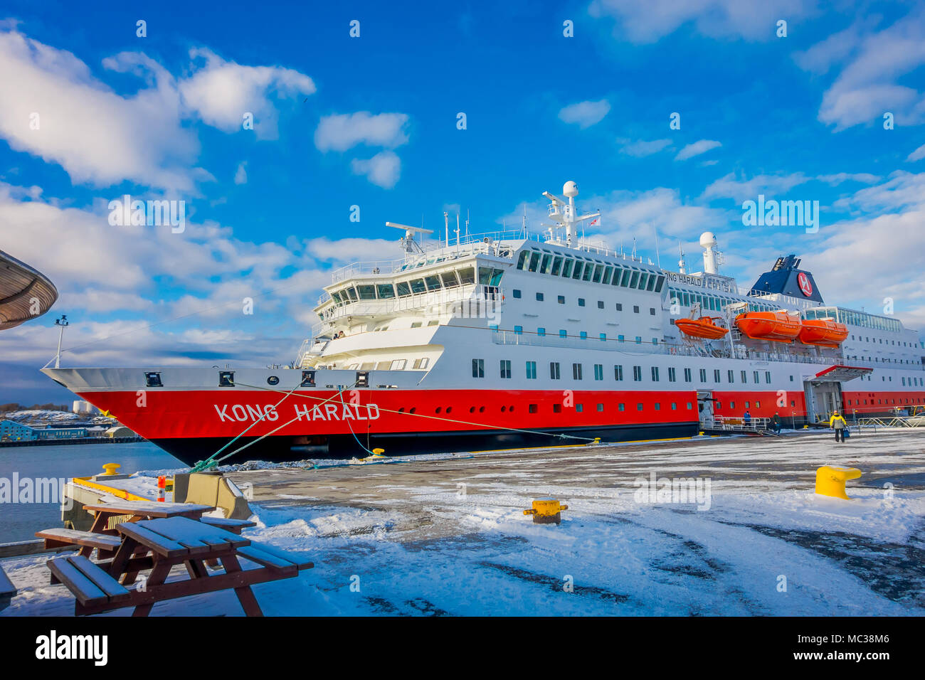 Bodo, Norway - April 09, 2018: Outdoor view of Hurtigruten coastal vessel KONG HARALD, is a daily passenger and freight shipping service parked in the coast of Bodo Stock Photo