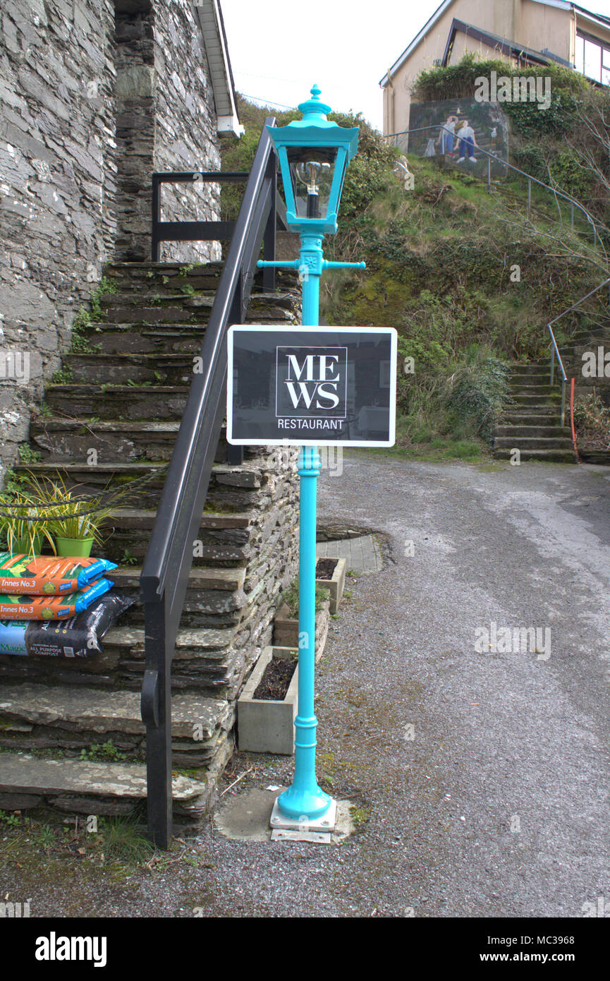 cast iron lamp post repainted and being used as a direction sign to a restaurant in baltimore, west cork, ireland a popular tourist destination. Stock Photo