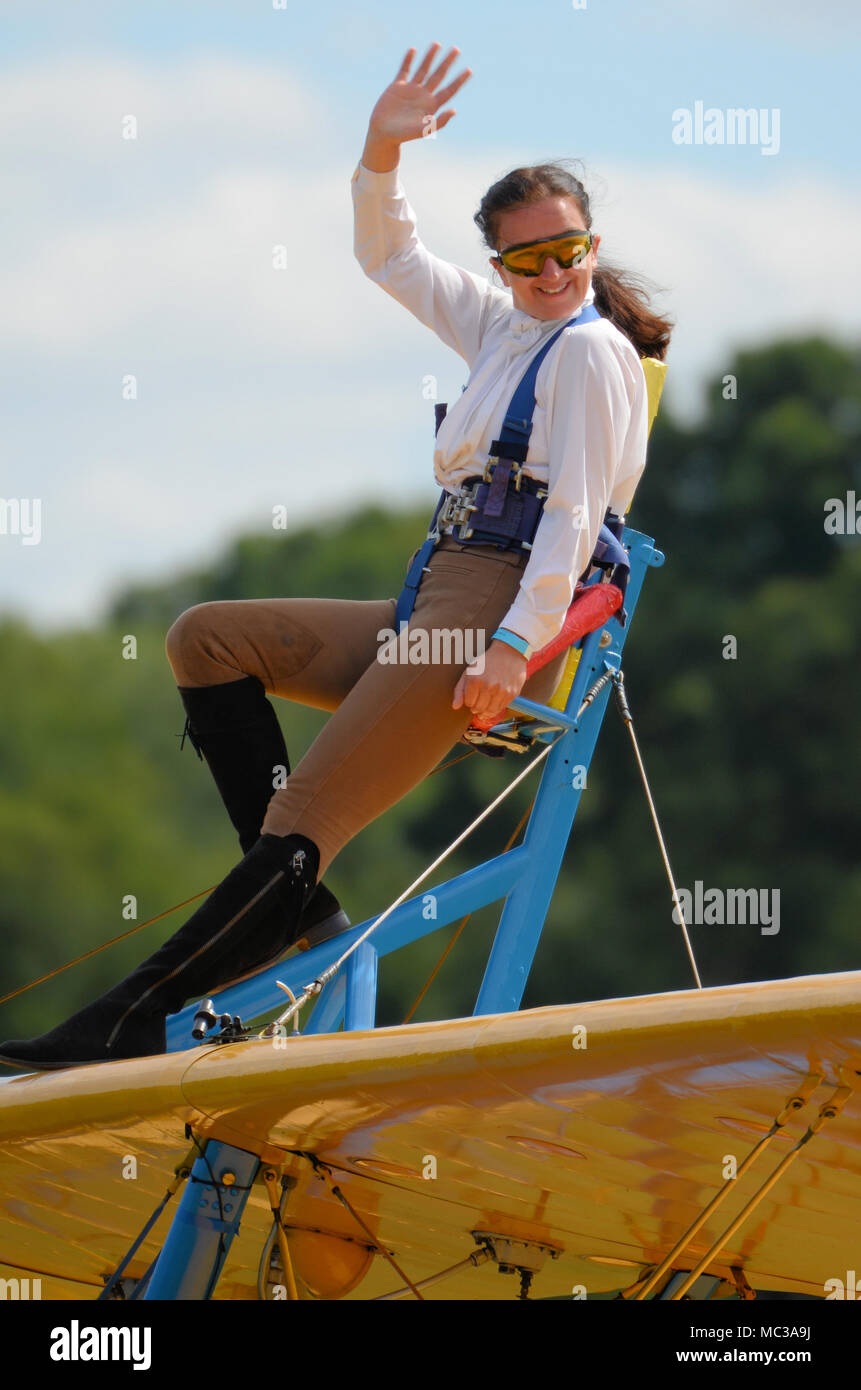 Sarah Niles wingwalking on a Boeing Stearman at Damyns Hall Aerodrome, Essex, UK, with Aerobatic Tactics. Girl on the wing, wing walking Stock Photo